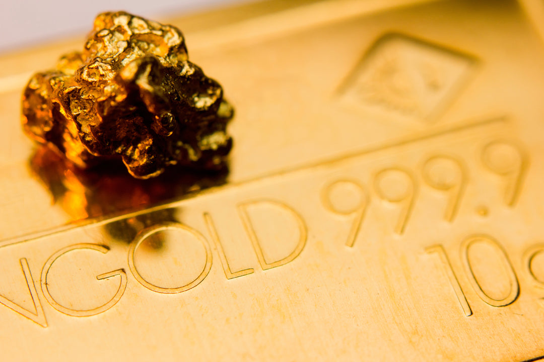 Gold bar with a gold nugget on top, featuring '999.9' purity marking.