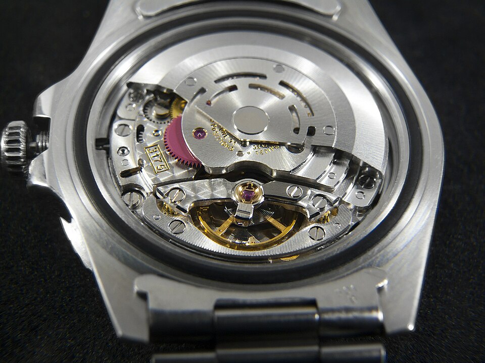 Close-up of a Rolex watch movement on a dark background
