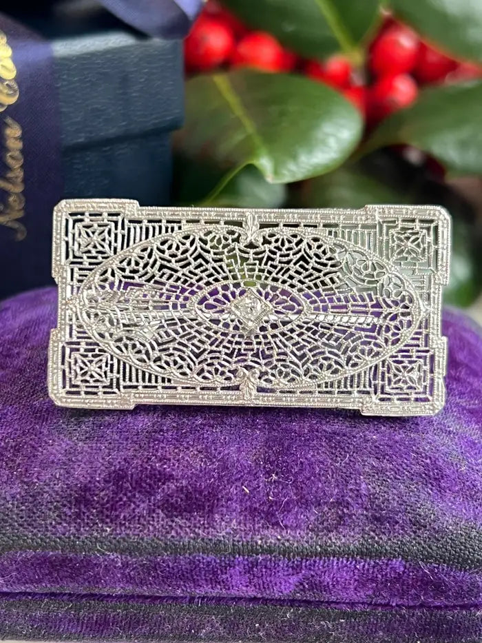An estate Art Deco diamond filigree brooch