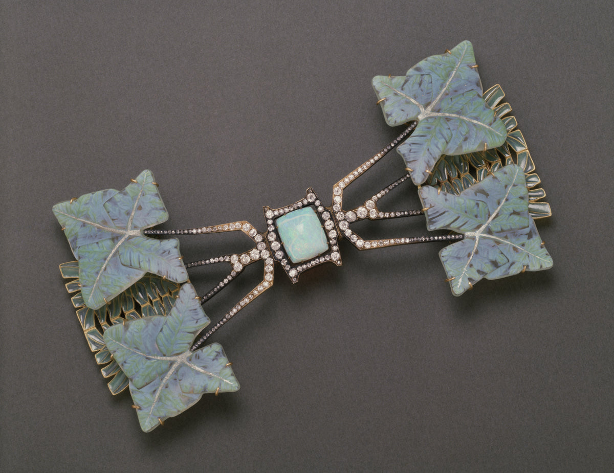 The fern leaves brooch by Rene Lalquie containing a central cushion-shaped opal, opalescent cameo glass, diamonds, and green enamel.
