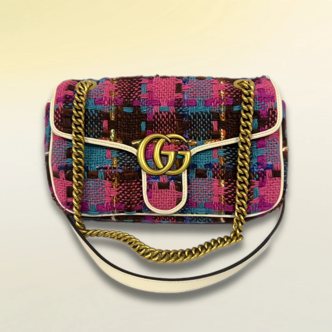 A multi-color tweed Gucci brand handbag with gold-tone brand logo and accents