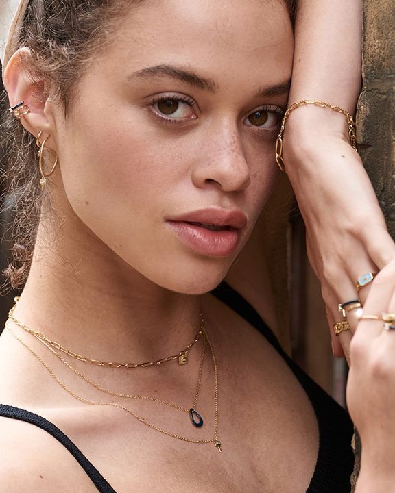 gold-plated key necklace stacked on model