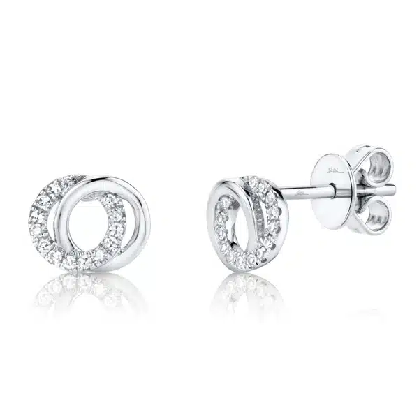A pair of 14 karat white gold stud earrings each with 2 circles overlapping and with one circle set completely with diamonds