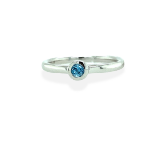 One sterling silver solitaire ring bezel-set with a 3mm round blue topaz
