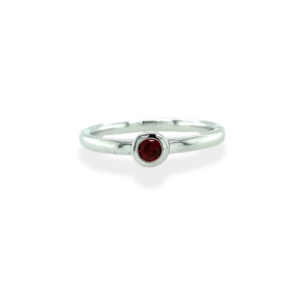 One sterling silver solitaire ring with a 3 mm round garnet in a bezel setting.