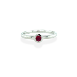 One sterling silver solitaire ring containing a 3mm round-faceted pink tourmaline in a bezel setting.