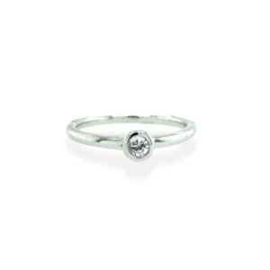 One sterling silver solitaire ring containing a 3mm round faceted white sapphire in a bezel setting.