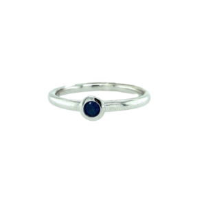 One sterling silver blue sapphire ring containing a 3mm round blue sapphire in a bezel setting.