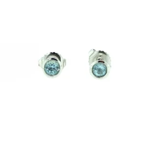 One pair of sterling silver stud earrings each with a 3mm round-faceted blue topaz in a bezel setting. Secured with friction posts and backs.
