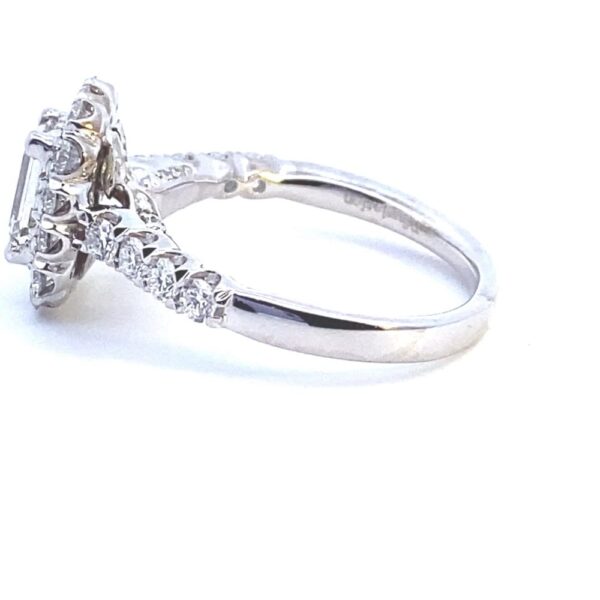 A 14 karat white gold lab-grown diamond engagement ring with a center emerald-cut diamond and round brilliant diamonds in the halo and in the band