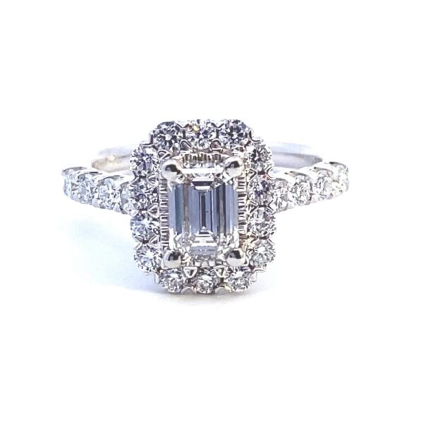 A 14 karat white gold lab-grown diamond engagement ring with a center emerald-cut diamond and round brilliant diamonds in the halo and in the band