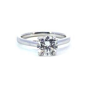 One 14 karat white gold solitaire engagement ring with a lab-grown round brilliant diamond weighing 1.54 carats in a cathedral setting
