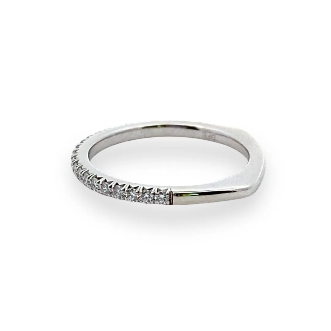 One 14 karat white gold classic wedding band containing 21 round brilliant-cut diamonds weighing 0.26 carat total weight in pave settings.