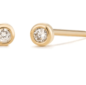 One pair of 14 karat yellow gold stud earrings by Aurelie Gi with 2 round-faceted diamonds weighing 0.03 carat total weight in bezel settings