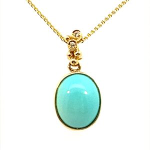 One 14 karat yellow gold pendant necklace by Lali with an oval-shaped cabochon turquoise in a bezel setting with diamond accents in the bail.