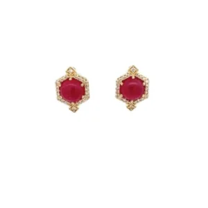 One pair of 14 karat yellow gold stud earrings from the LoveFire Greenland Ruby collection by Tache featuring two 6mm round cabochon rubies weighing 2.84ctw in six-prong settings. The earrings also feature 48 single-cut diamonds weighing 0.16ctw with matching H-I color and I1-I2 clarity prong set in a pointed hexagon halo around the cabochon rubies with milgrain detailing on all edges. The earrings have 14 karat yellow gold tension posts and earrings backs and are stamped with "14k ODI" and the Greenland Ruby Logo.