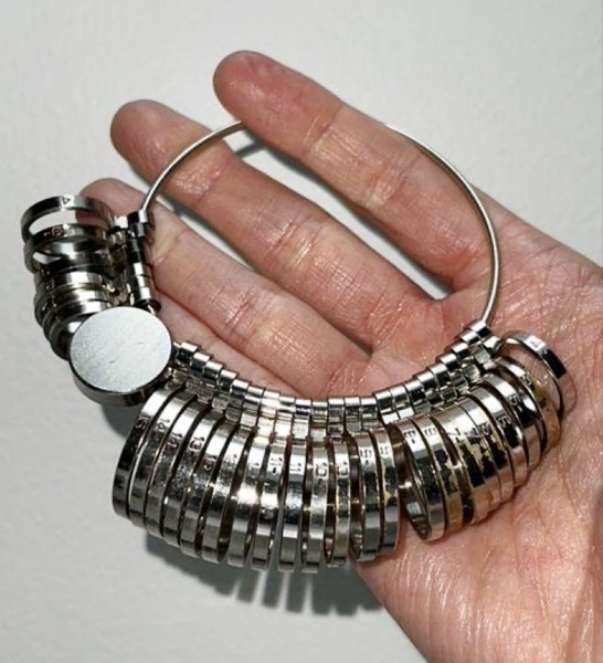 A professional ring sizer tool, featuring multiple rings of metal on a larger keyring.