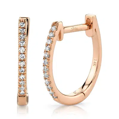 One pair of 14 karat rose gold huggie hoop earrings by Shy Creation set with single-cut diamonds weighing 0.08 carat total weight.