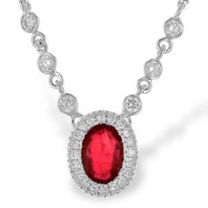 Oval Ruby and Diamond Necklace is a 14 karat white gold ruby and diamond halo necklace with a 0.70 carat oval ruby and round diamonds weighing 0.24 carat total weight with G color and SI1/SI2 clarity in a halo around the ruby and bezel set in portion of the chain. The necklace measuring 18" long. By Allison Kaufman.