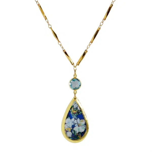 Lilies and Blue Topaz Necklace - 22 karat gold leaf pendant necklace with a drop pendant starting with a round blue topaz in a bezel setting that drops to a teardrop-shaped pendant with an enamel image of lilies primarily with white, cobalt blue, and mint green.