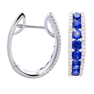 A pair of white gold hoop earrings set with round-faceted blue sapphires and accented by diamonds