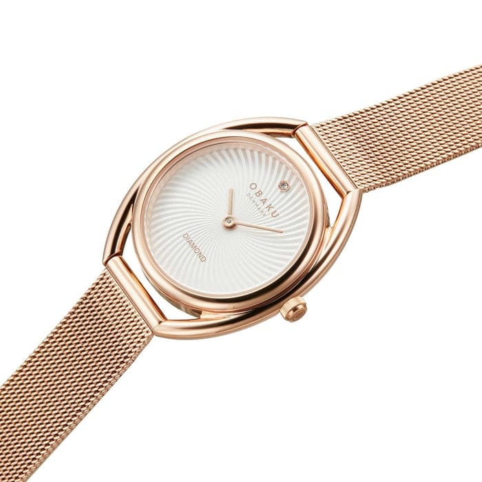 A Juvel Rose rose gold-plated watch by Obaku featuring a rose gold-tone case and bracelet, a whilte dial, and rose gold-tone two-hand movement.