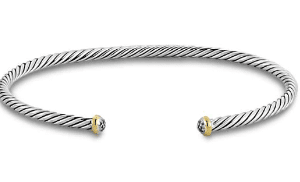 A sterling silver twisted cable cuff bracelet with yellow gold and diamond end caps