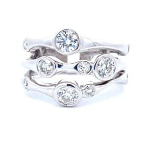 A white gold fashion band featuring round brilliant diamonds in a pattern reminiscent of echoes
