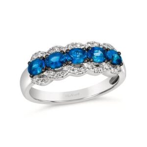 A white gold fashion ring set with blue sapphires and accented by diamonds in a lace motif