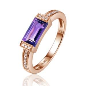 14 karat rose gold Art Deco-inspired ring with a center baguette-cut amethyst weighing 0.98 carat in a bar setting accented by 20 round brilliant diamonds weighing 0.05 carat total weight