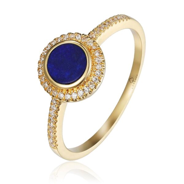 A yellow gold ring with a round cabochon lapis lazuli with a diamond halo and diamonds in the band