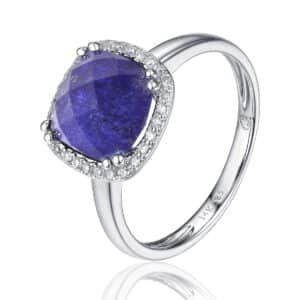 A 14 karat white gold fashion ring by Luvente with a cushion-shaped checkerboard-faceted lapis lazuli weighing 2.48 carats surrounded by a halo of diamonds