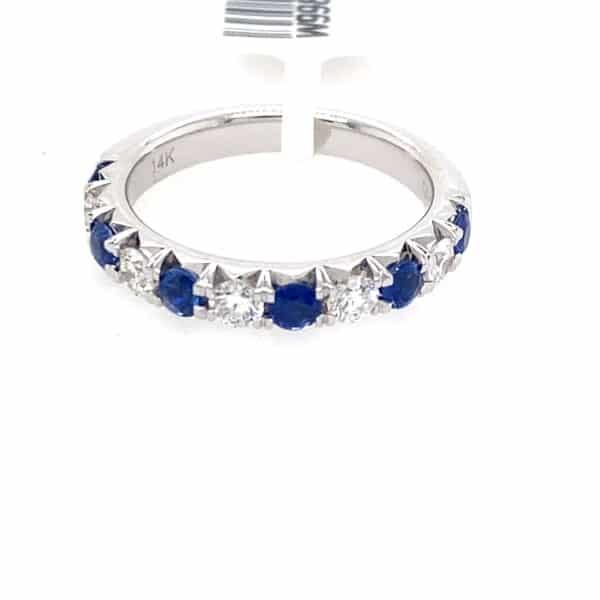 A white gold wedding-style straight band set with alternating round blue sapphires and diamonds
