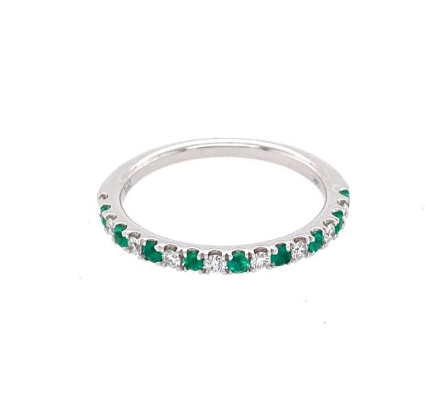 A white gold wedding-style straight band featuring alternating round emeralds and diamonds