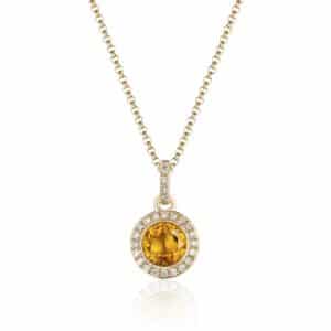 A yellow gold pendant and necklace with a round-faceted citrine and a diamond halo