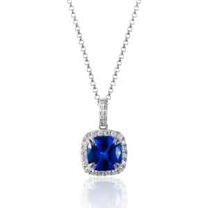 A white gold necklace featuring a cushion-shaped faceted tanzanite with a cushion-shaped halo of diamonds