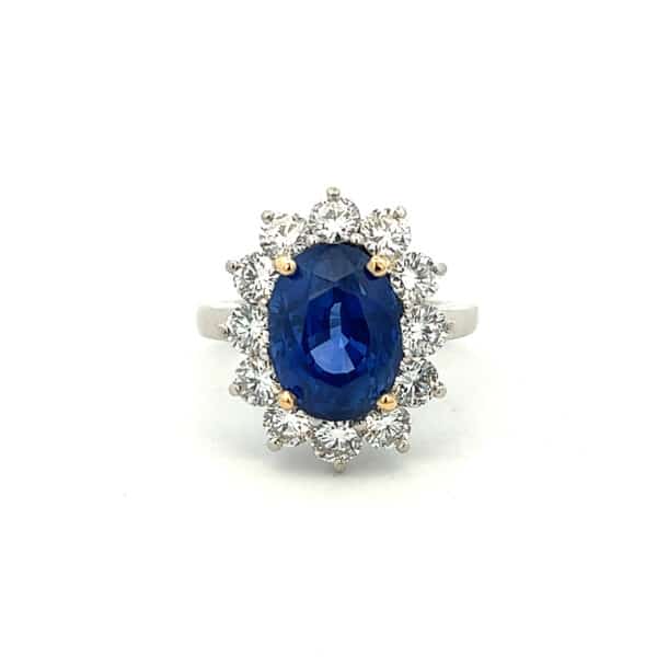Estate Blue Sapphire and Diamond Halo Ring in platinum with 18 karat yellow gold center prongs
