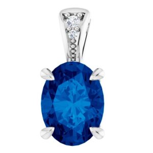 A white gold pendant set with an oval lab-grown blue sapphire with 2 lab-grown diamonds in the bail