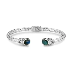 One sterling silver hinged cuff bracelet featuring a cross-hatch design and 2 oval cabochon labradorites, with one set in each end of the bracelet. From the Royal Bali Collection by Samuel B.