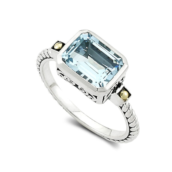 One sterling silver Eirini ring with solid 18 karat yellow gold accents and an emerald-shaped blue topaz