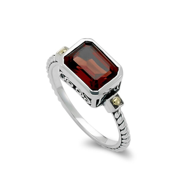 One sterling silver Eirini ring with solid 18 karat yellow gold accents and an emerald-shaped garnet