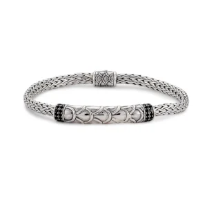 A sterling silver tulang naga bracelet with an elegant accented bar pave-set with round faceted blacks spinels
