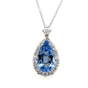an 18 karat white gold pendant necklace containing a pear-shaped faceted aquamarine with a diamond halo and diamond accent in the bail