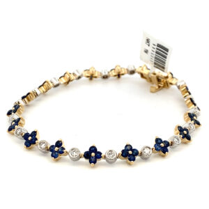 One 14 karat two-tone link bracelet featuring round blue sapphires in yellow gold and round diamonds in white gold settings