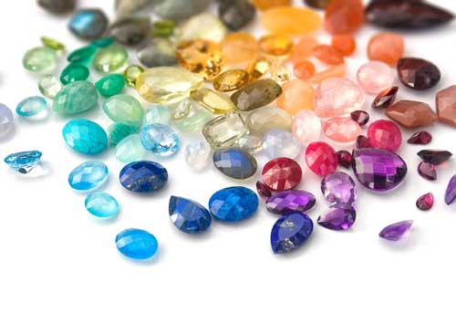 A collection of colored diamonds and gemstones to consider for a custom engagement ring design