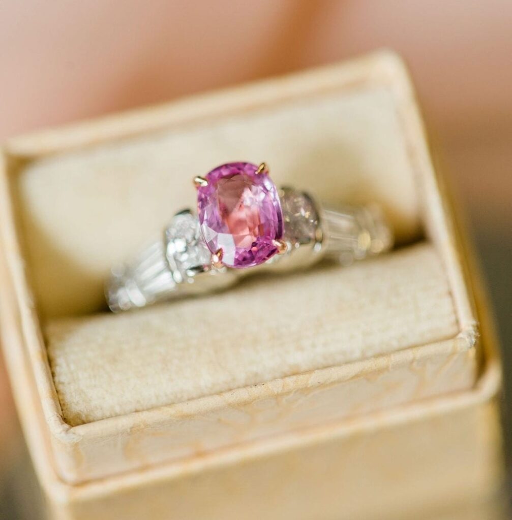 custom engagement ring with an oval pink sapphire and diamonds in a white gold setting