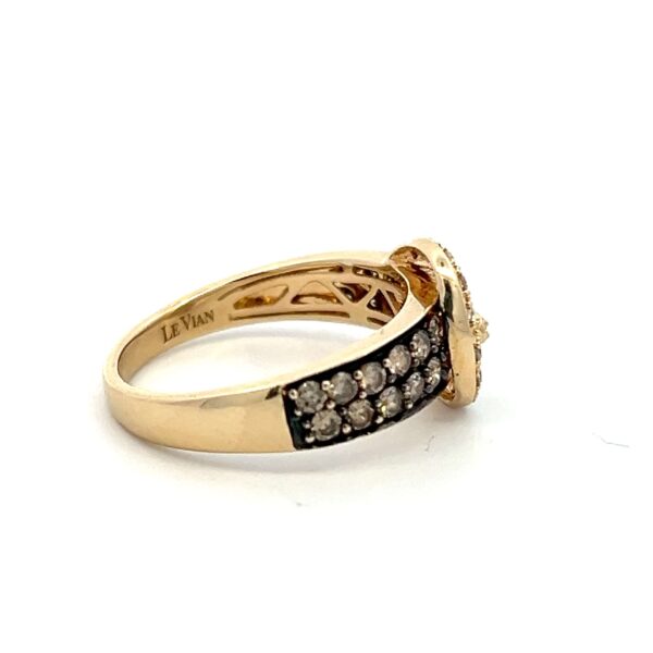 One estate 14 karat yellow gold buckle-style ring with bronze and white diamonds