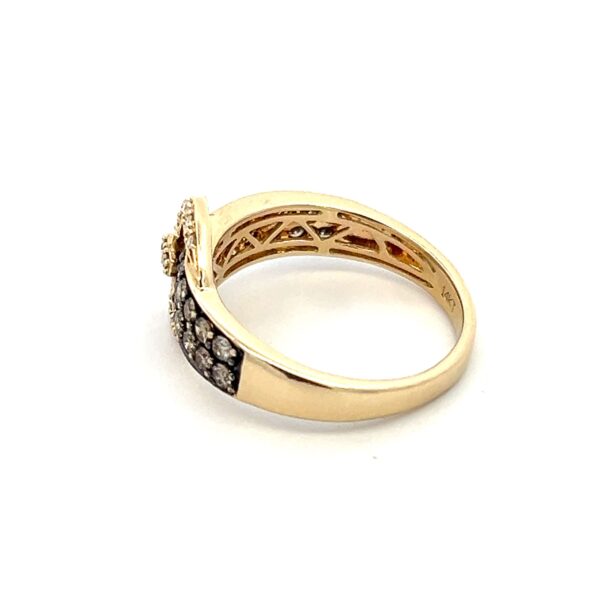 One estate 14 karat yellow gold buckle-style ring with bronze and white diamonds
