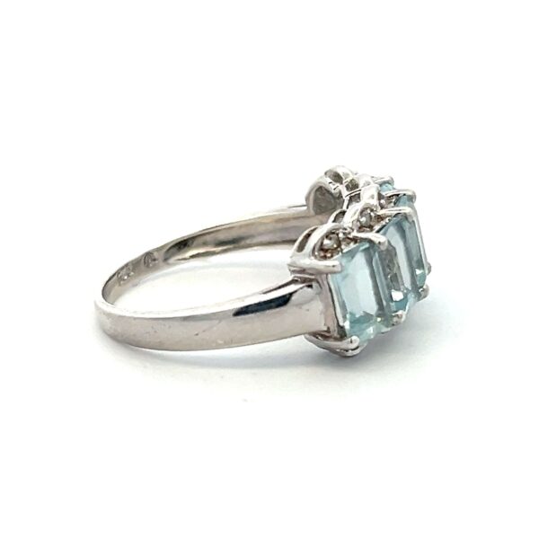 One estate sterling silver five-stone ring with 5 emerald-cut blue topazes and 10 round diamond accents