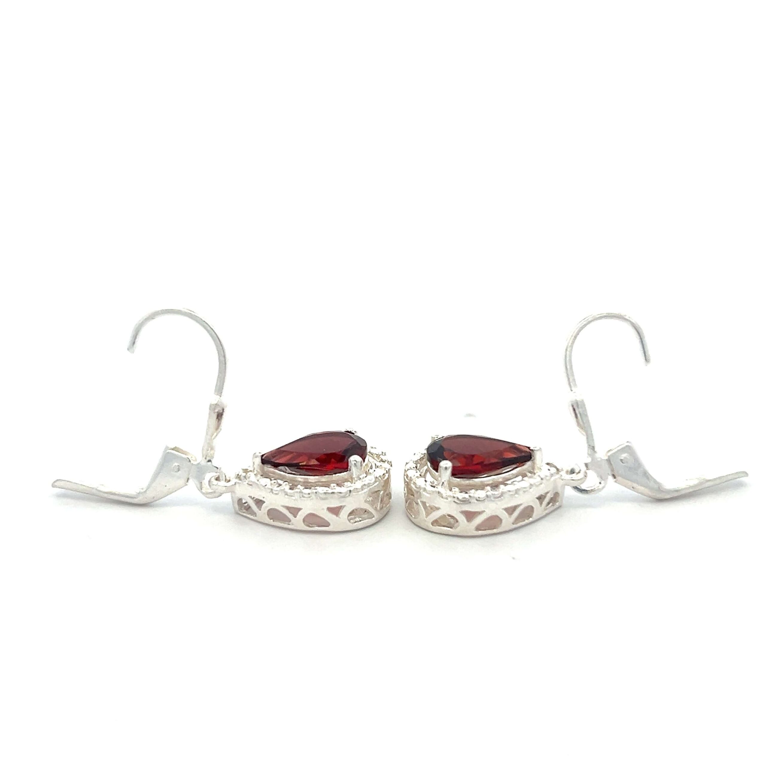 One estate pair of sterling silver drop earrings with pear-shaped faceted garnets and textured silver halos